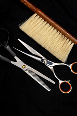 professional hairdressing tools are arranged on a dark background