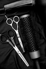 professional hairdressing tools are arranged on a dark background