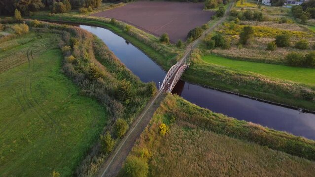 Old steel tram bridge over the Ner River in the city of Lutomiersk, Poland.