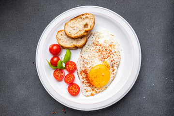 fried egg, tomato, breakfast healthy meal food snack diet on the table copy space food background rustic top view