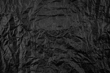 Black crumpled paper background texture. 