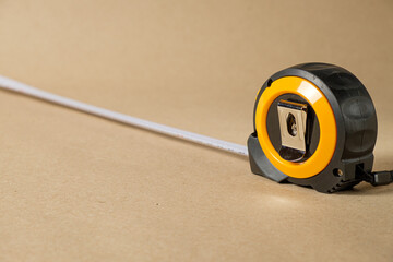 Cartridge meter. Yellow measuring tape isolated on craft paper background. With
 space for text