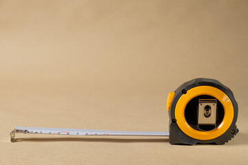 Cartridge meter. Yellow measuring tape isolated on craft paper background. With
 space for text