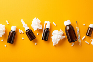 Illness concept. Top view photo of remedy spray and syrup transparent brown bottles crumpled...