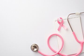 Breast cancer awareness concept. Top view photo of pink silk ribbon stethoscope and notebook on...