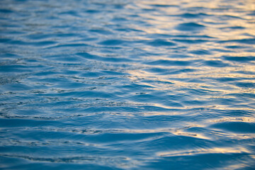 Closeup seascape surface of blue sea water with small ripple waves