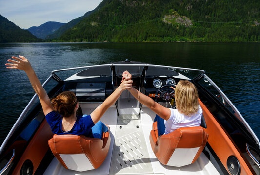 travel vacation for beautiful European females driving speedboat