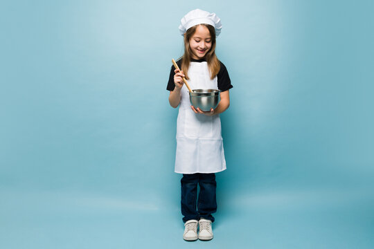 Talented kid baking a cake and playing chef
