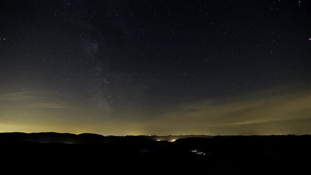 Time lapse shot at night of ruin of Falkenstein with mountain range of Vosges. The clear sky shows stars and the Milky Way.