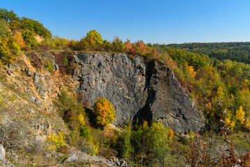 rocks surrounded by trees in autumn colors