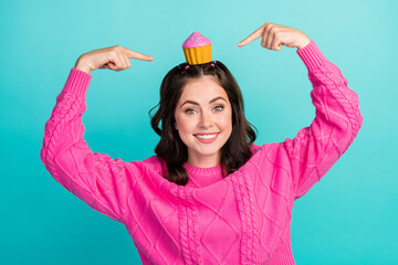 Photo of young attractive cute woman wear pink knitted sweater directing fingers head muffin...