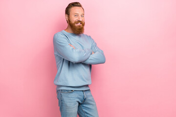 Portrait photo of young redhair man wear blue sweater folded hands confident professional empty space isolated on pink color background