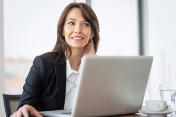 Shot of an attractive businesswoman working on a laptop in an office