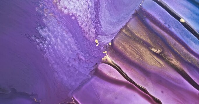 Lilac paint abstract flow 4k footage. Gold violet art ink background. Shiny golden purple color flow liquid. Acrylic texture in motion. Colorful glitter fluid pattern. Beautiful vibrant backdrop