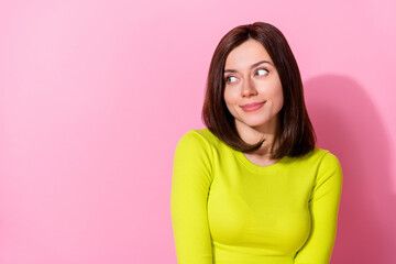 Photo of gorgeous satisfied minded lady look interested empty space imagine isolated on pink color background