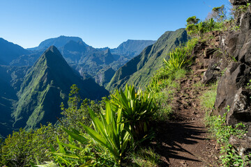 Fototapeta na wymiar View of the mountain peaks and tourist path on the hill, in Reunion Island in the summertime