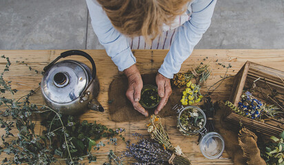Grandmother makes tea with medicinal herbs. Selective focus.