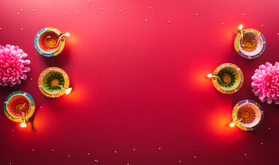 Happy Diwali - Clay Diya lamps lit during Diwali, Hindu festival of lights celebration. Colorful...