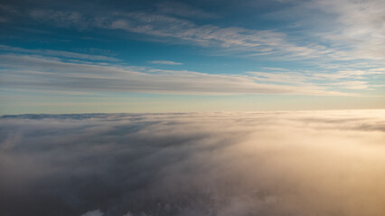 Sunrise breaking through the thick white fog at the top of Vuokatti Hill, a ski resort in Vuokatti,...