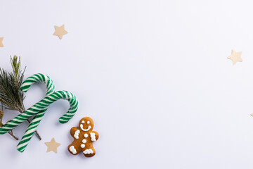 Image of christmas decoration with gingerbread man and copy space on white background