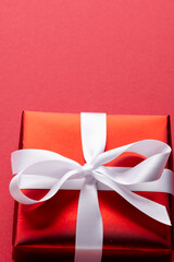 Image of red christmas gift decoration and copy space on red background