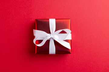 Image of red christmas gift decoration and copy space on red background