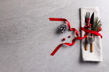 Image of christmas place setting with cutlery and copy space on grey background