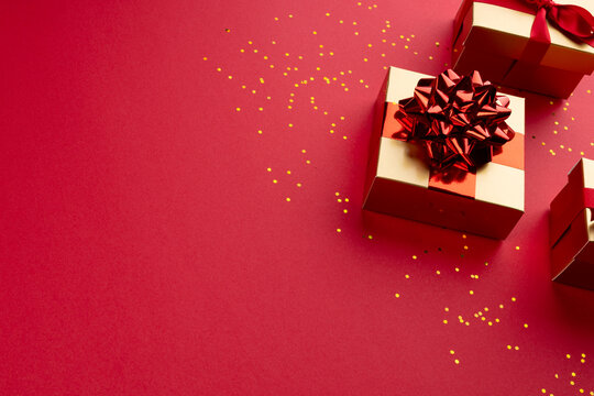 Image of christmas decoration with gifts and copy space on red background