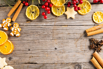 Image of gingerbread man cinnamon sticks and christmas decoration with copy space on wood