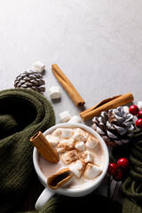 Image of cup with hot chocolate with marshmallows, christmas decorations and copy space on grey