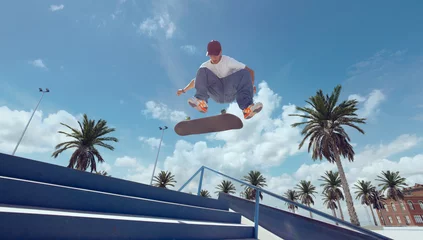 Fototapeten Skateboarder doing a trick in a skate park © VIAR PRO studio