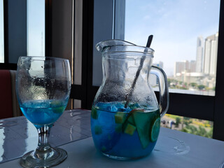 Glass of tasty blue mojito cocktail 