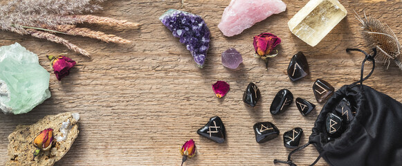 Set of different crystals and rune stones on wood