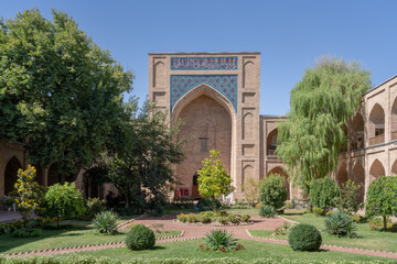 Landscape view of the mosque iwan and green courtyard of Kukeldash madrasa, ancient monument and...