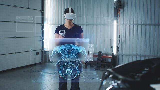 Car service manager uses virtual reality with futuristic augmented reality diagnostic software with holographic 3D engine visualisation.