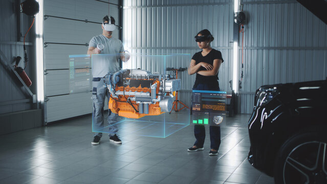 Two service manager engineers use virtual reality technology to diagnose an eco-friendly car engine with an augmented reality interface and 3D engine visualization