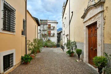 A narrow street between the old stone houses of Pratola Peligna, a medieval village in the Abruzzo region of Italy.