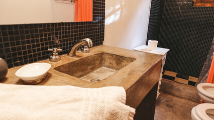 bathroom details with rustic stone sink and vintage details
