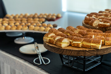 coffee break hotel during conference meeting, corporate revent with tea and coffee catering, decorated catering banquet table with variety of different pastry and bakery, with croissants and cookies