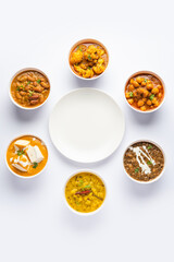 Group of Indian vegetarian dishes, hot and spicy Punjabi cuisine meal assortment in bowls