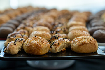 coffee break hotel during conference meeting, corporate revent with tea and coffee catering, decorated catering banquet table with variety of different pastry and bakery, with croissants and cookies