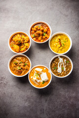 Obraz na płótnie Canvas Group of Indian vegetarian dishes, hot and spicy Punjabi cuisine meal assortment in bowls