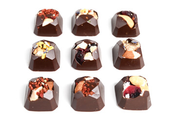 Set of handmade bonbons on white background. Exclusive handcrafted chocolate candies isolated on white