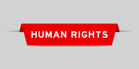 Red color inserted label with word human rights on gray background