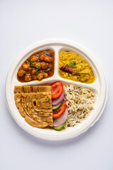 Indian mini meal parcel platter, combo thali with chole Masala, roti, dal tarka, jeera rice, salad - obrazy, fototapety, plakaty