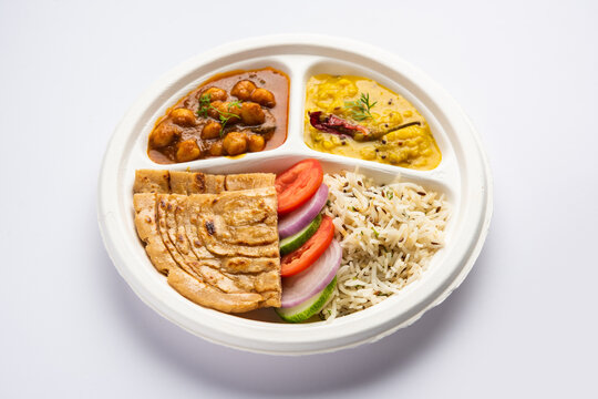 Indian mini meal parcel platter, combo thali with chole Masala, roti, dal tarka, jeera rice, salad