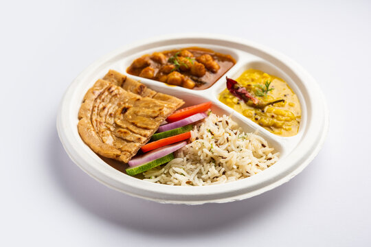 Indian mini meal parcel platter, combo thali with chole Masala, roti, dal tarka, jeera rice, salad