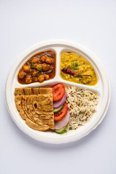 Indian mini meal parcel platter, combo thali with chole Masala, roti, dal tarka, jeera rice, salad