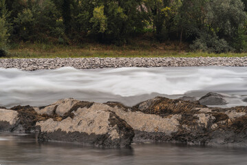 Long exposure of a river with silk effect in the water, with the rocks in focus.