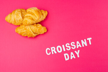 Image of croissants and croissant day on pink background